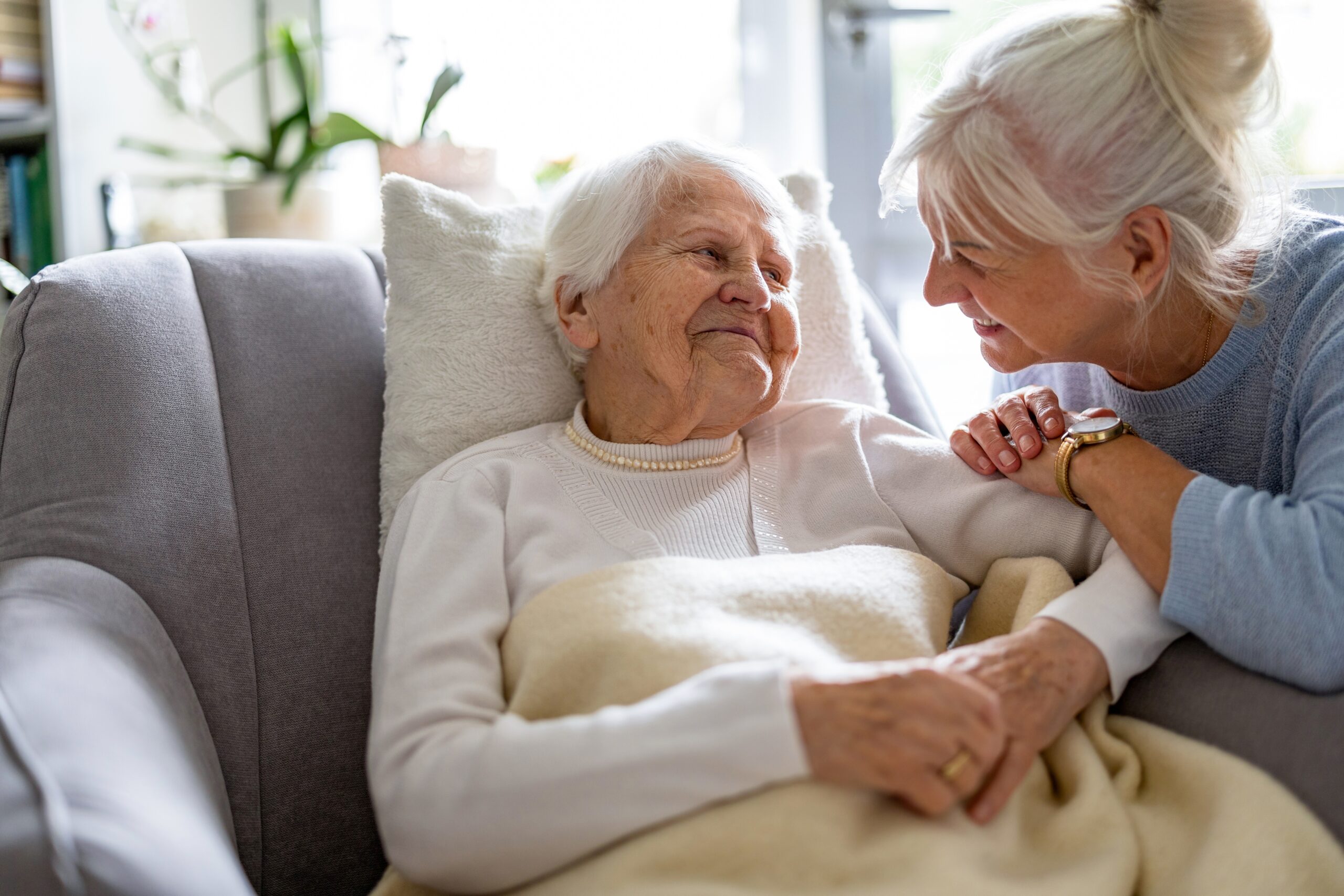 senior woman smiling at her adult daughter